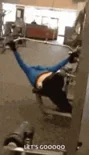 A gym-goer with their legs in the air beside a weight machine, captioned ‘IT’S GOOOOD’.
